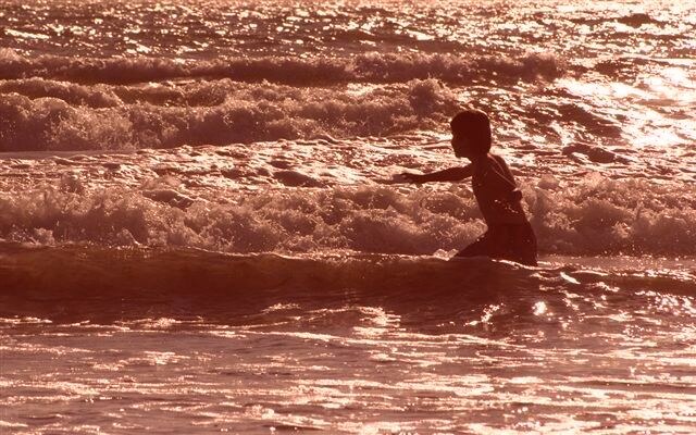 Max playing in the surf at sunset